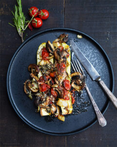 Überbackene Zucchini-Hälften mit Ofengemüse aus Pilzen, Tomaten und Zwiebel - mit einem Würzöl - von Herr Grün kocht